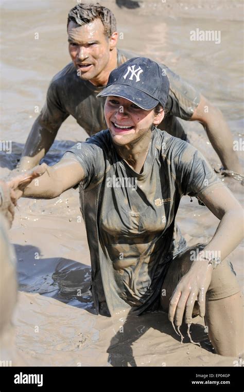 Mud Covered Woman Competitor Waist Deep In Mud Lake Obstacle Course