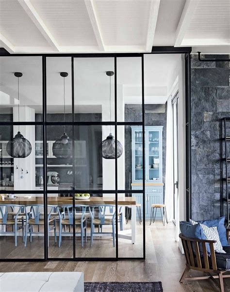 Each panel of the glass partition walls has a blind in the double glazing cavity. Modern Monochrome Kitchen Diner with Blue Chairs and ...