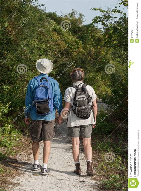 Mature Couple Holding Hands And Hiking On Nature T Stock