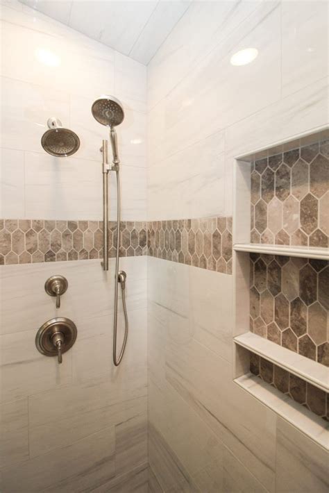 In most common examples, you will a shower stall placed carefully along one of the. Marble Tiled Shower Walls With Brown Tiled Accent in 2020 ...