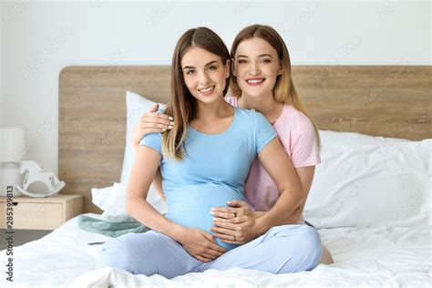 Happy Pregnant Lesbian Couple In Bedroom Stock Photo Adobe Stock