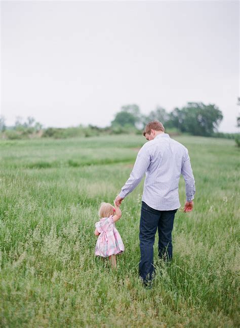 Father Holding The Hand Of His Daughter And Walking Away By Stocksy