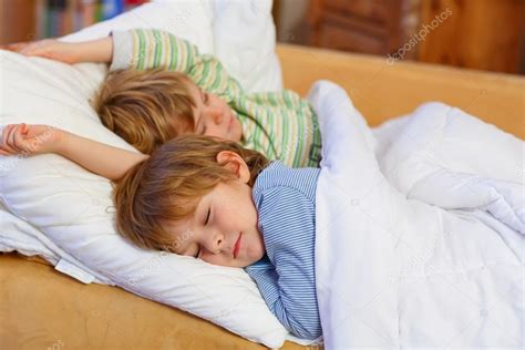 Two Little Blond Sibling Boys Sleeping In Bed Stock Photo By