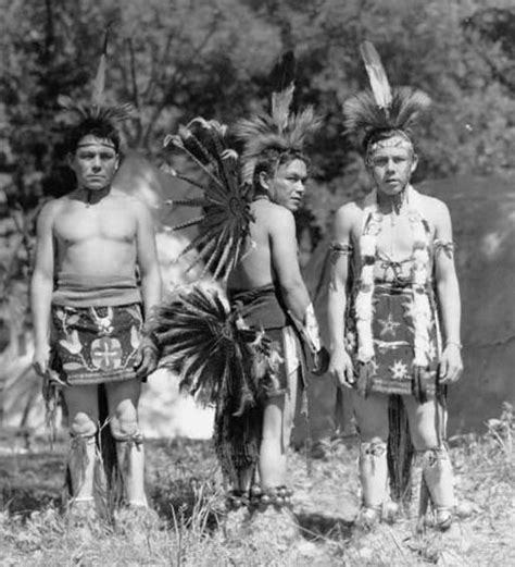 three native american men standing next to each other