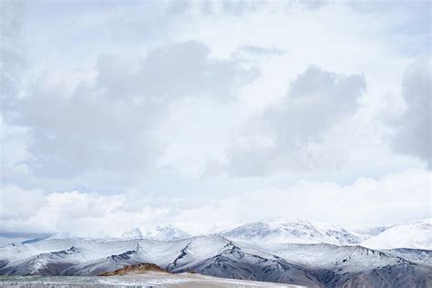 Panoramic View Of Snowy Mountains Under Cloudy Sky Photograph By Oleg
