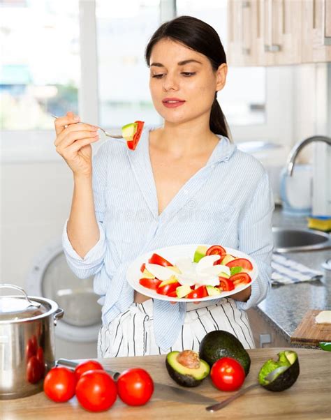 woman tasting vegetable salad in kitchen stock image image of