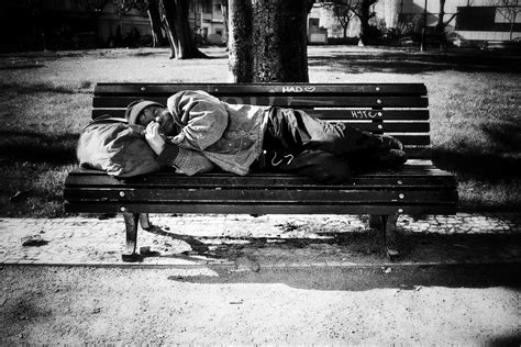 Homeless Man Sleeps On A Park Bench Lisbon Global Warming