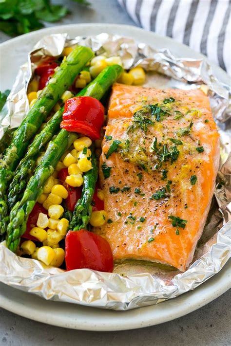 The tinfoil boat creates a steam trap for the salmon, which helps it cook evenly throughout and infuses the salmon with whatever ingredients you flavor it with. These salmon foil packets are fresh salmon fillets and vegetables coated in herb butter, then ...