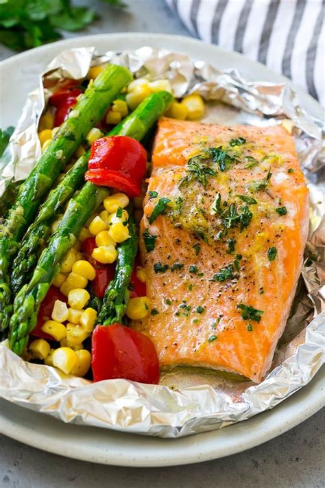 Wrap the ends of the foil to form a spiral shape. These salmon foil packets are fresh salmon fillets and vegetables coated in herb butter, then ...