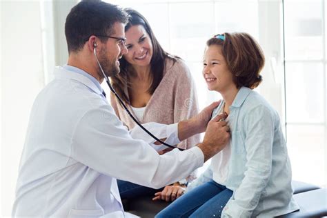 Mother With Her Daughter Being Examined With Stethoscope By Pediatrician Stock Image Image Of