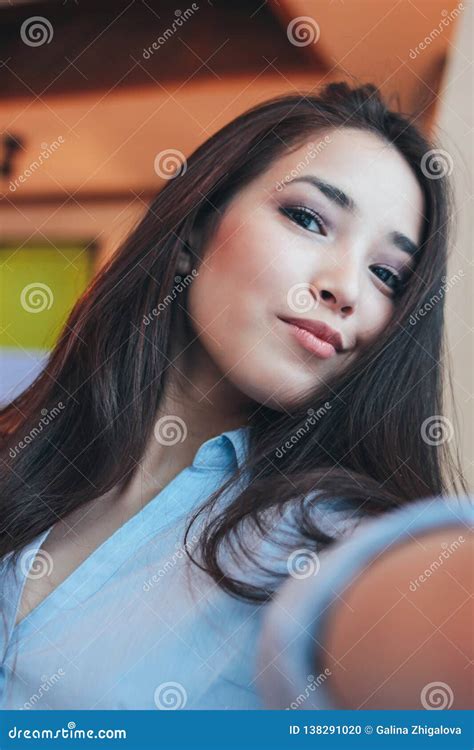 Beautiful Charming Brunette Smiling Asian Girl Taking Selfie On Frontal Camera At Cafe Stock