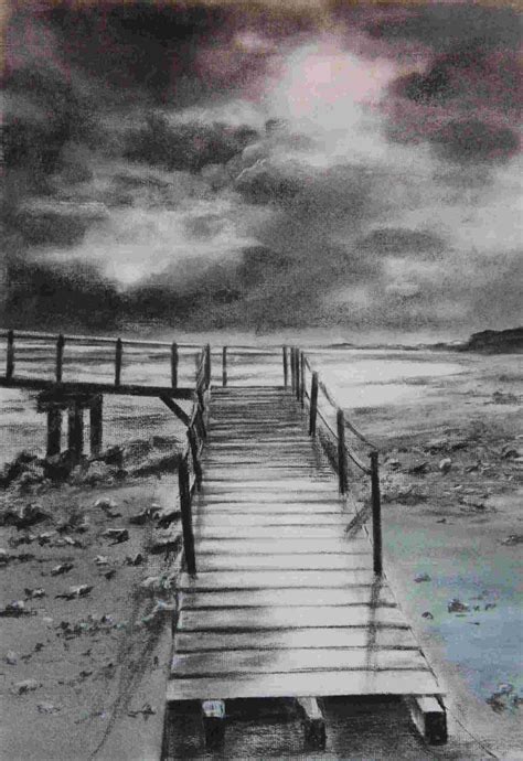 A Black And White Photo Of A Dock On The Beach With Clouds In The Sky