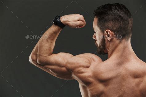 Close Up Of A Muscular Bodybuilder Flexing Biceps Stock Photo By