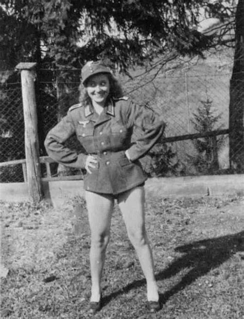 An Old Black And White Photo Of A Woman In Uniform Posing With Her Hands On Her Hips