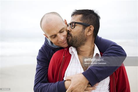 Two Men Kissing On Beach Bildbanksbilder Getty Images