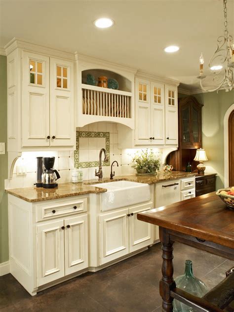 The baskets under the counter add even more of an organized feel. Custom Tile in Green French Country Kitchen | HGTV