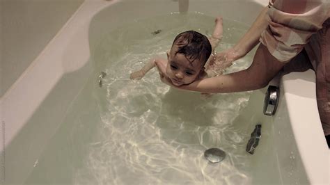 Mother Bathing Her Baby By Stocksy Contributor Aleksandar Novoselski Stocksy