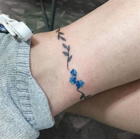 A modern twist on the arm band, an ankle band is a straightforward, unfussy way to step up the game of an ankle tattoo. Picture Of Floral ankle tattoo design