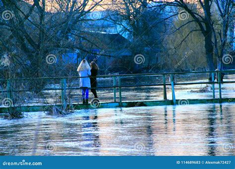 Young Girls Are Photographed On Background Of Flooding In Spring