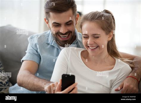 Laughing Couple Sitting On Couch Hi Res Stock Photography And Images Alamy