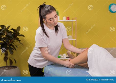 Professional Masseur Woman Doing Legs Massage For Her Client At Spa Salon In The Massage Room