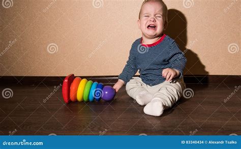 Little Baby Sitting On The Floor And Crying Stock Photo Image Of