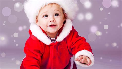 Smiley Cute Baby Boy Is Crawling On Floor Wearing Santa
