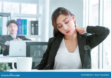 Female Office Worker Suffering From Office Syndrome Using Her Hand To