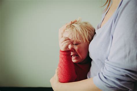 Mother Comforting Crying Little Baby Stock Photo Download Image Now