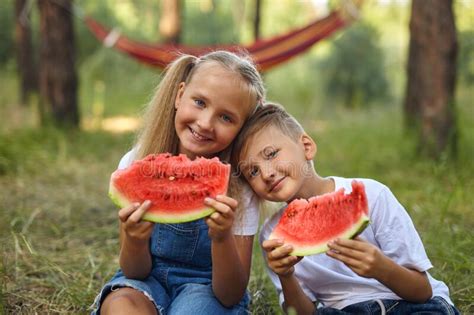 Cute Kids Eating Watermelon In The Garden Stock Photo Image Of Friend