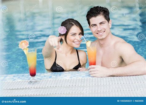 Portrait Of A Couple Smiling And Drinking A Cocktail In A Pool Stock Image Image Of Cocktail