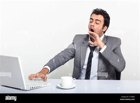 Businessman Yawning At Work Stock Photo Alamy