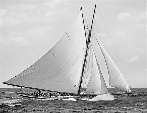 Black And White Photograph Of A Sailboat In The Ocean With People On Board