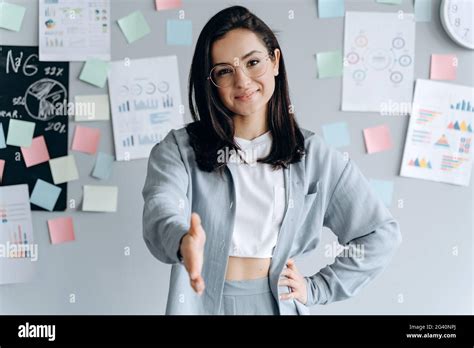 Beautiful Business Girl Reaches Out To Say Hello In The Office Smiling