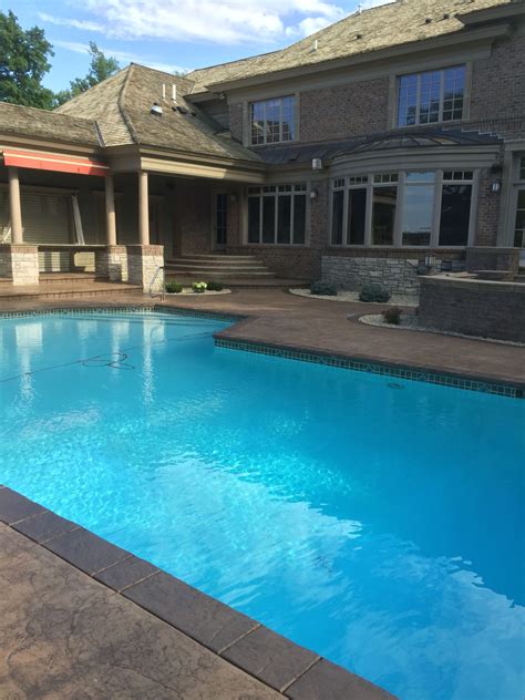 Stamped And Colored Concrete Pool Deck With Custom Chiseled Stone