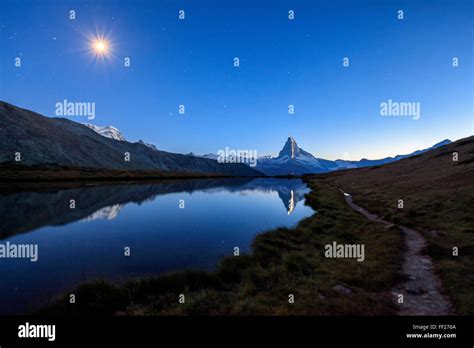 Full Moon And Matterhorn Illuminated Reflected In Lake Stellisee