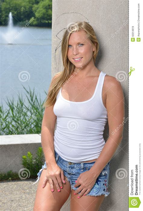 Blonde Woman White Tank And Jean Shorts Stock Image