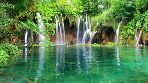 Green Nature Beautiful Waterfall And Mountain Lake