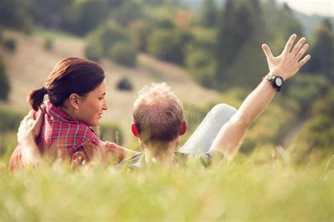 Loving Couple Lying In Green Grass On The Meadow Stock Photo Image Of
