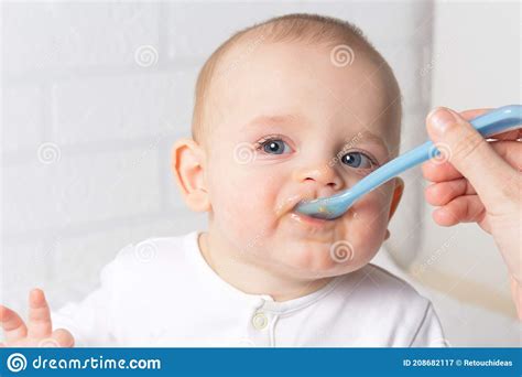 Mother Feeding Baby With Blue Baby Spoon Stock Image Image Of Happy