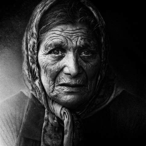 A Black And White Photo Of An Old Woman With Wrinkles On Her Face