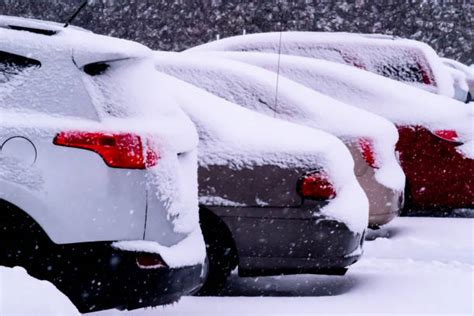 Car In Snowy Parking Lot Stock Photos Pictures And Royalty Free Images