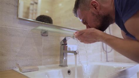 Morning Hygiene Man Washes His Face With Clean Water In The Bathroom Slow Motion Stock Video