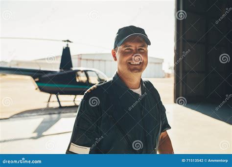 Happy Male Pilot Standing In Airplane Hangar Stock Photo Image Of