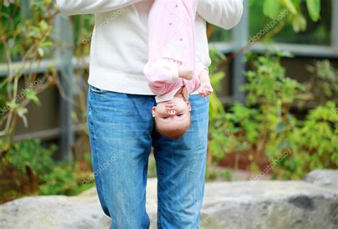 Dad Holds The Baby Upside Down Outdoor — Stock Photo © Iriana88w