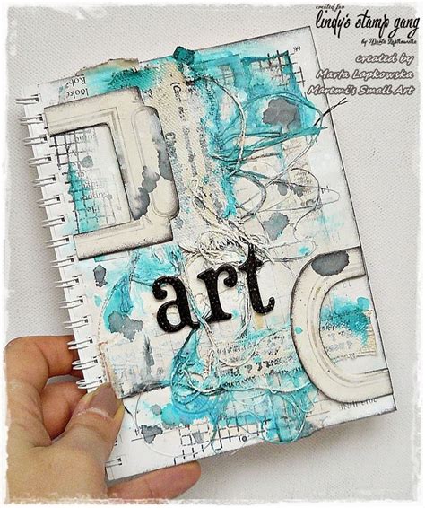 A Hand Holding An Altered Book With The Word Art On It