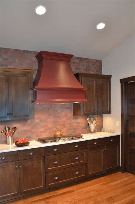 Here are top kitchen backsplash ideas that may change the mood and color of your kitchen. This burgundy painted stove top hood with red brick back ...