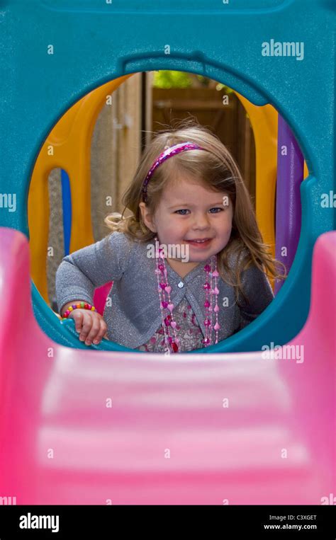 Vertical Portrait Of A Cute Little Girl Having Fun Playing On A