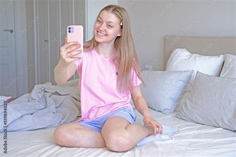 Cute Girl Years Old Sitting On The Bed Makes A Selfie Stock Photo Adobe Stock