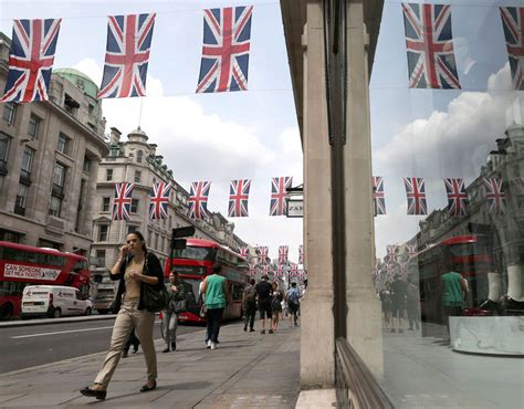 Shoppers Walk Underneath British Union Flags Hanging Above